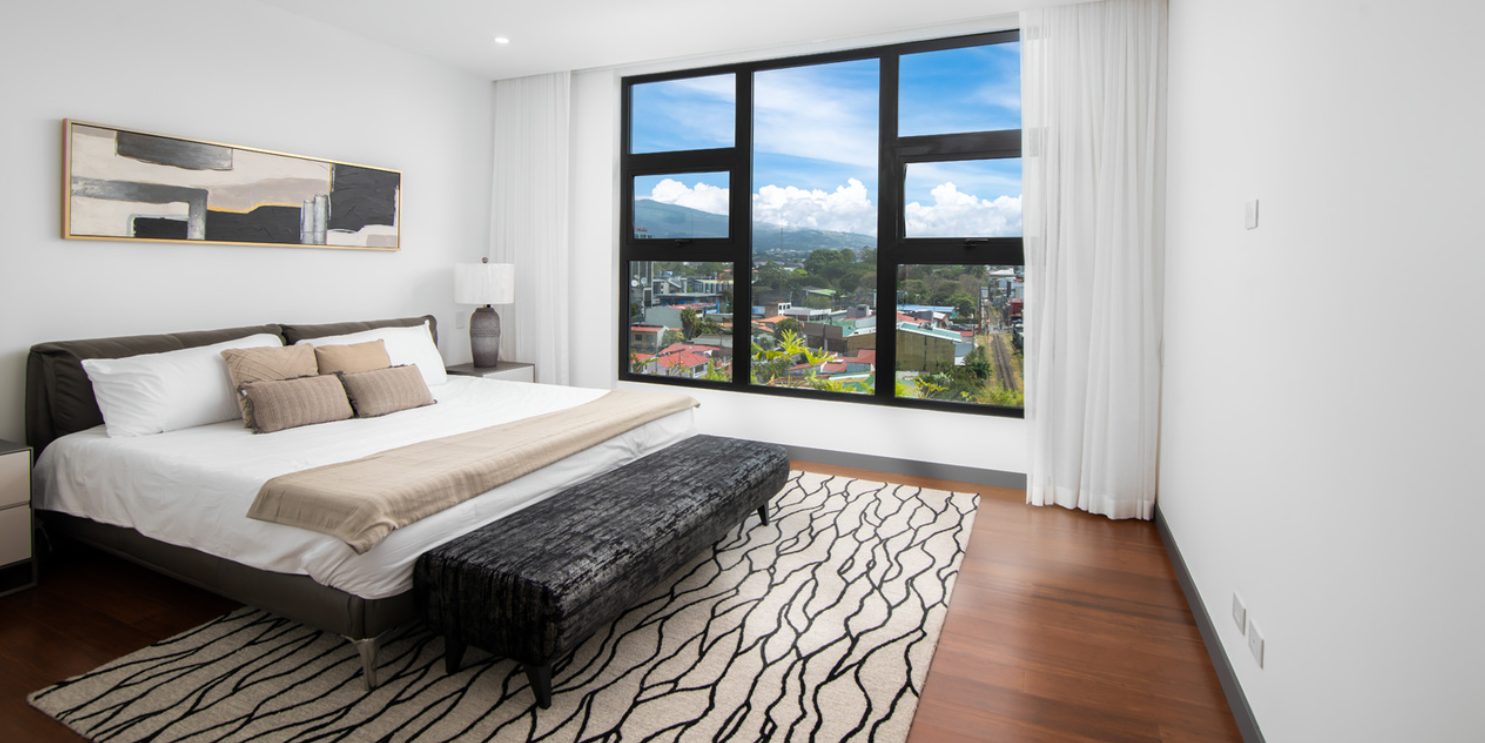 Bedroom with a patterned rug and mountain view