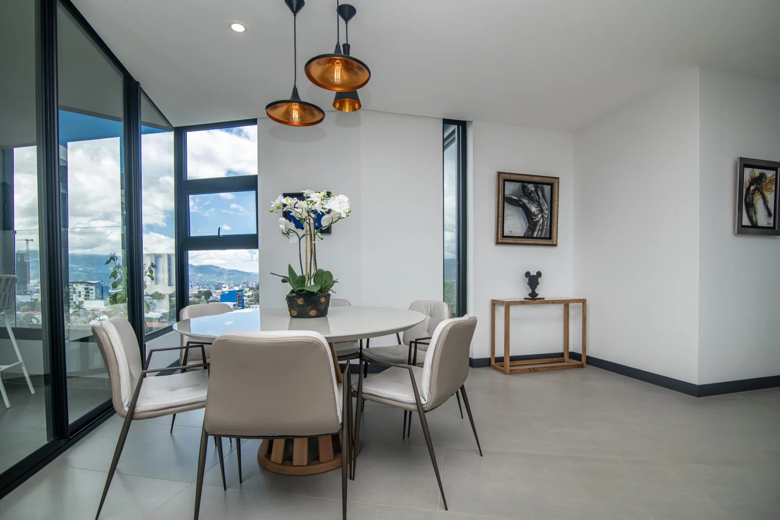Round dining table with copper pendant lights