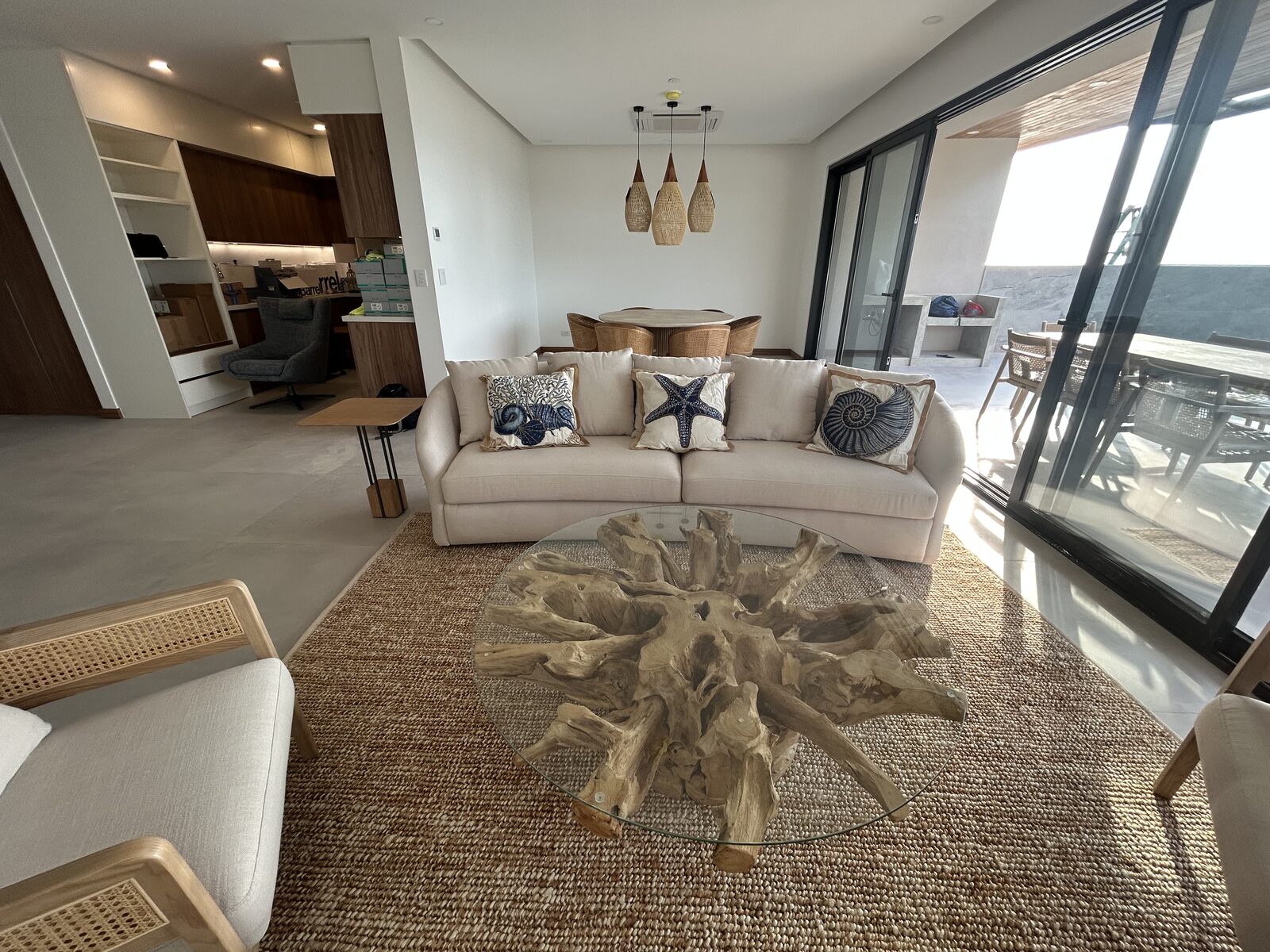 Living area with a sofa and a rattan armchair