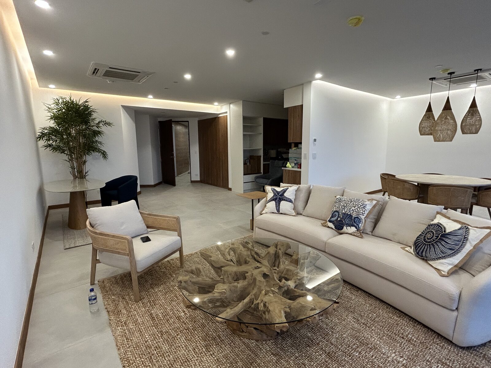 Sitting area with a rattan armchair, sofa, and coffee table